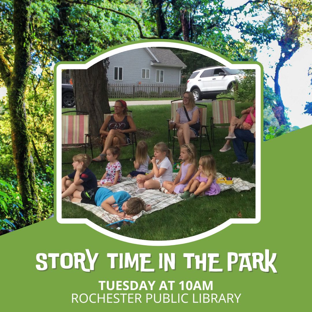 kids sitting in a park with adults listening